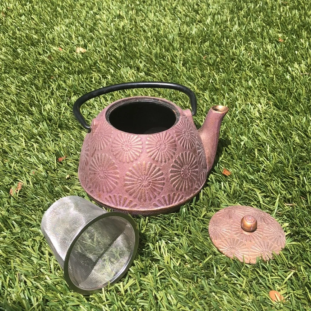 Cast iron tea pot with sunburst design